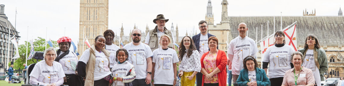 Members of the back the one in six hand-in delegation stand together. Big Ben is in the background.