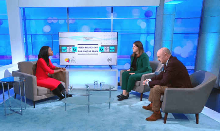 Three people talking animatedly on the set of Our Unique Brain.